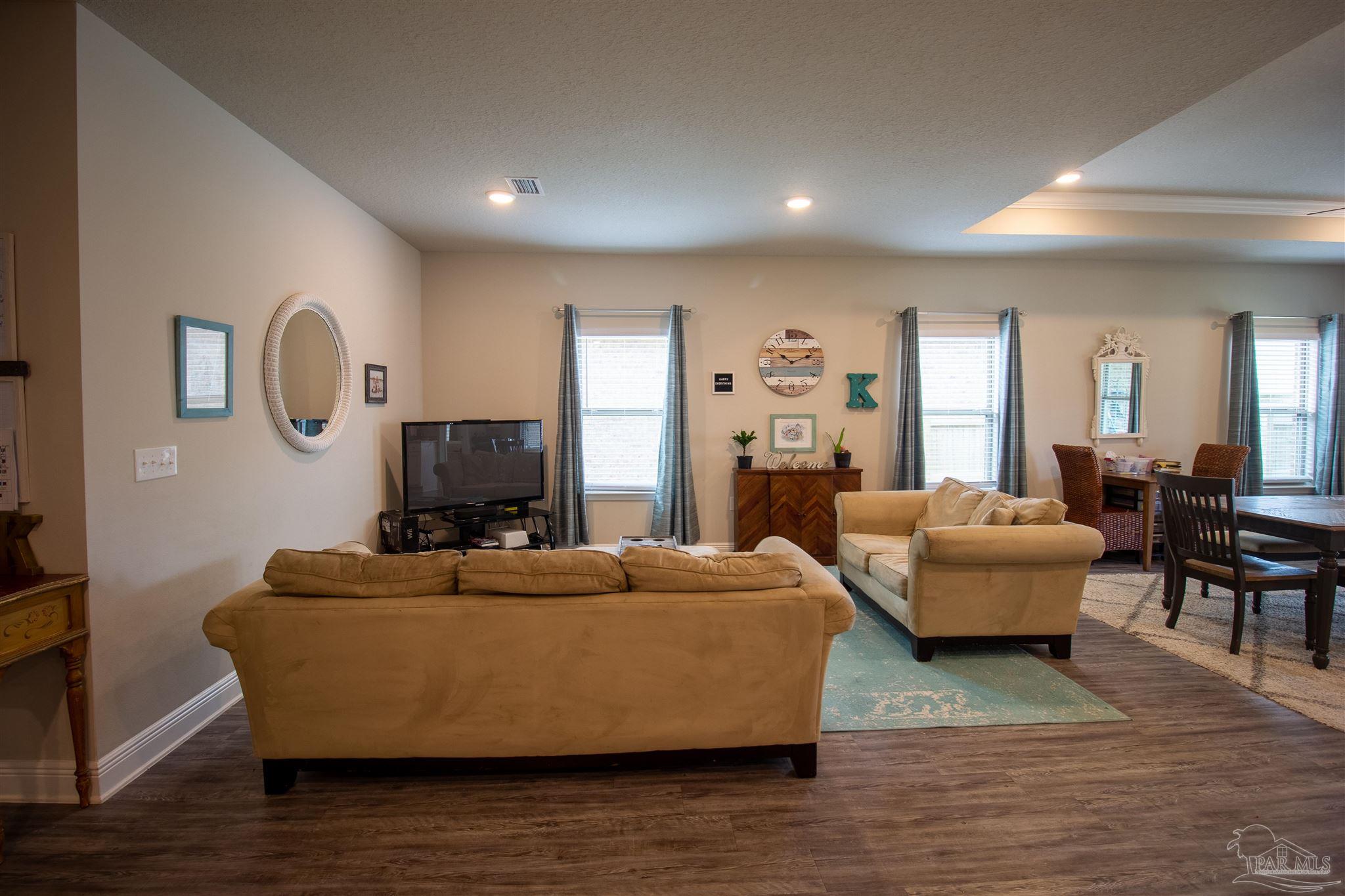 5375 Red Shoulder Road Milton, FL 32571 - Photo 7 of 38 a living room with furniture and a wooden floor