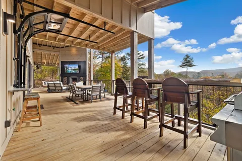 a view of a patio with dining table and chairs with wooden floor
