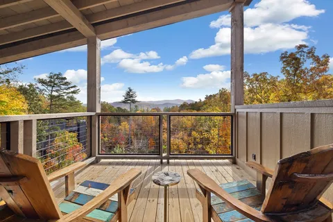 a view of a balcony with lake view and wooden floor