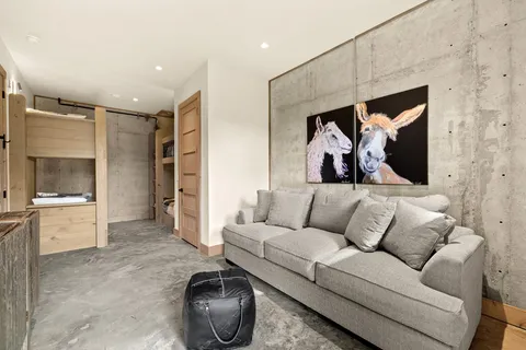 a living room with furniture and a painting on the wall