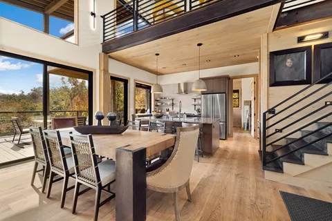 a large kitchen with a table and chairs