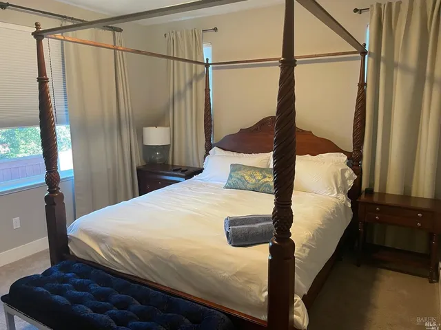 a bedroom with a bed window and a shower