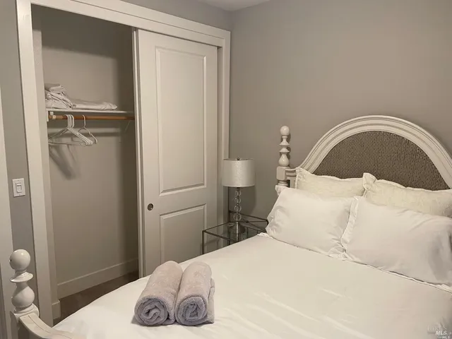 a bedroom with a bed and a lamp