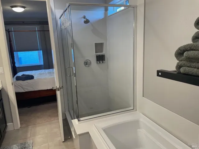 a bathroom with a tub and a shower