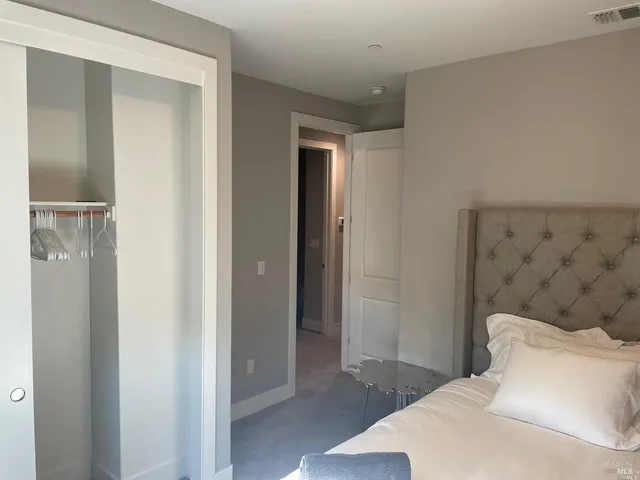 a bedroom with a bed and a mirror