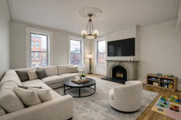 a living room with furniture a fireplace and a flat screen tv