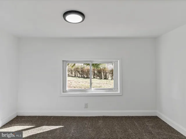 a view of a room with wooden floor and window