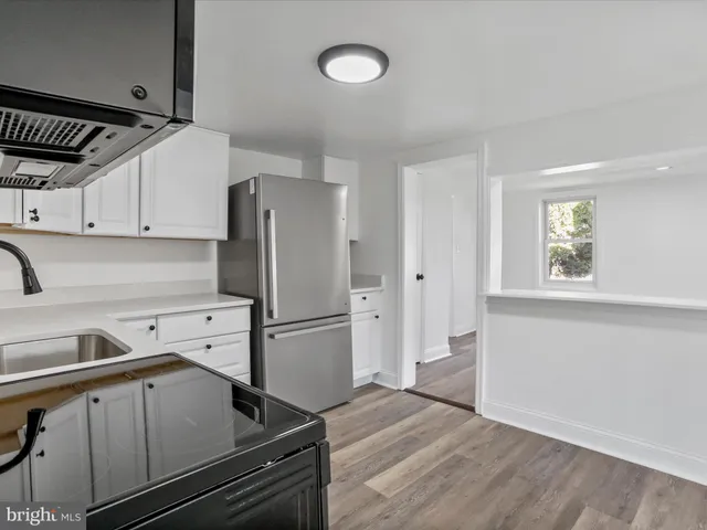 a kitchen with a refrigerator and a sink