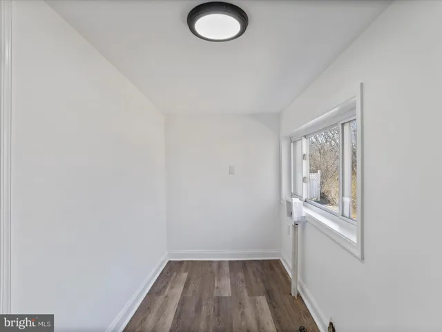 a view of a room with wooden floor and windows