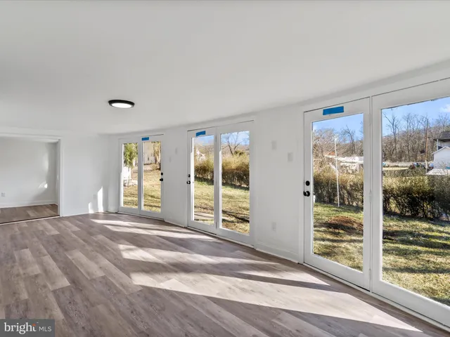 a view of a livingroom with wooden floor and windows