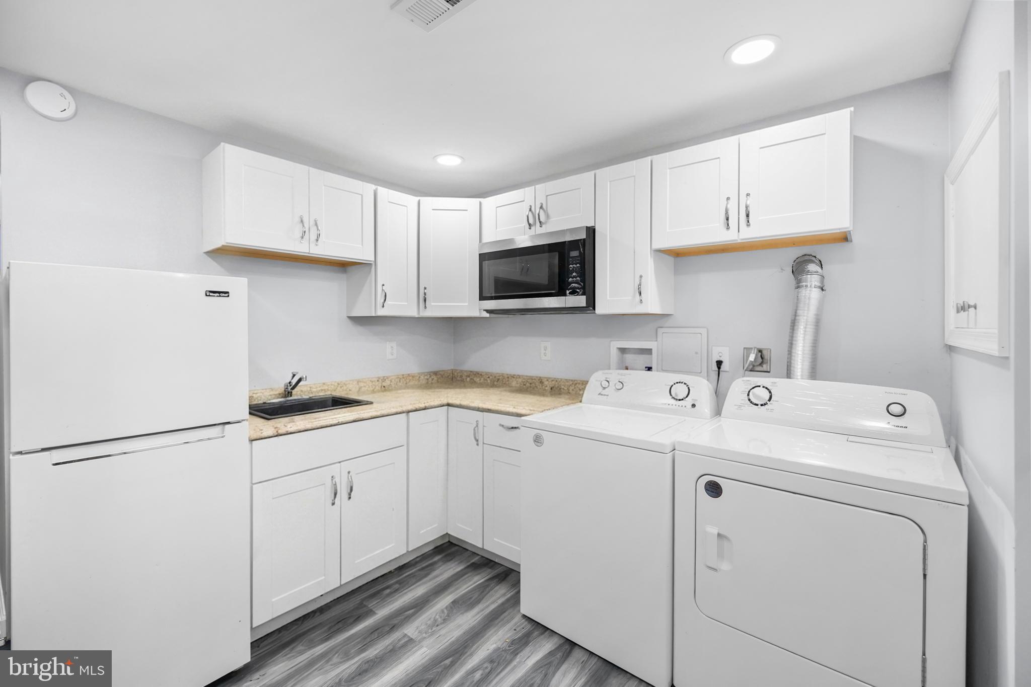 7402 Dunston Street Springfield, VA 22151 - Photo 31 of 37 a view of a kitchen with sink and cabinets