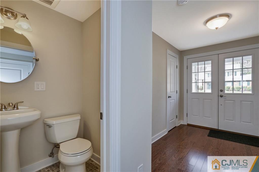 1103 Sawmill Road Mountainside, NJ 07092 - Photo 14 of 25 a bathroom with a toilet a sink and mirror