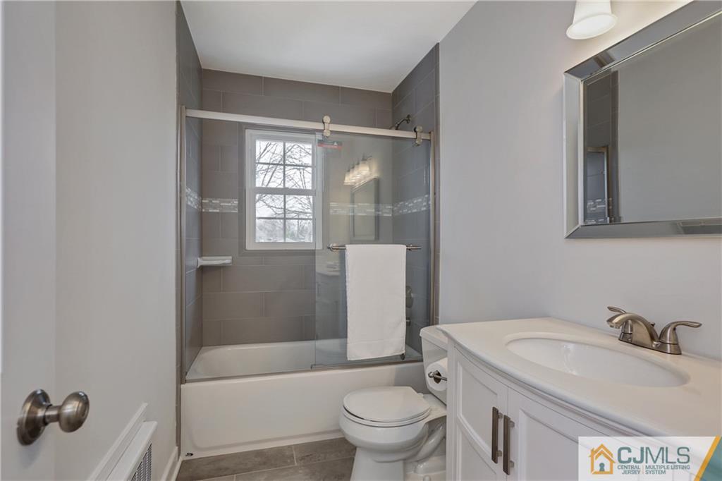1103 Sawmill Road Mountainside, NJ 07092 - Photo 17 of 25 a bathroom with a sink toilet and shower