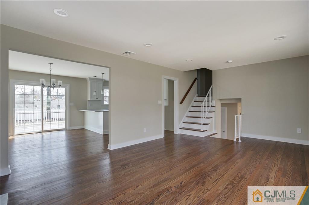1103 Sawmill Road Mountainside, NJ 07092 - Photo 10 of 25 a view of an empty room with wooden floor and stairs