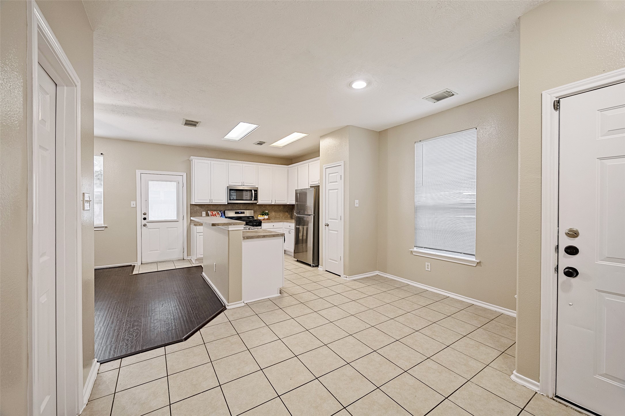 14334 Fairbuff Lane Houston, TX 77014 - Photo 5 of 15 a kitchen with white cabinets and stainless steel appliances