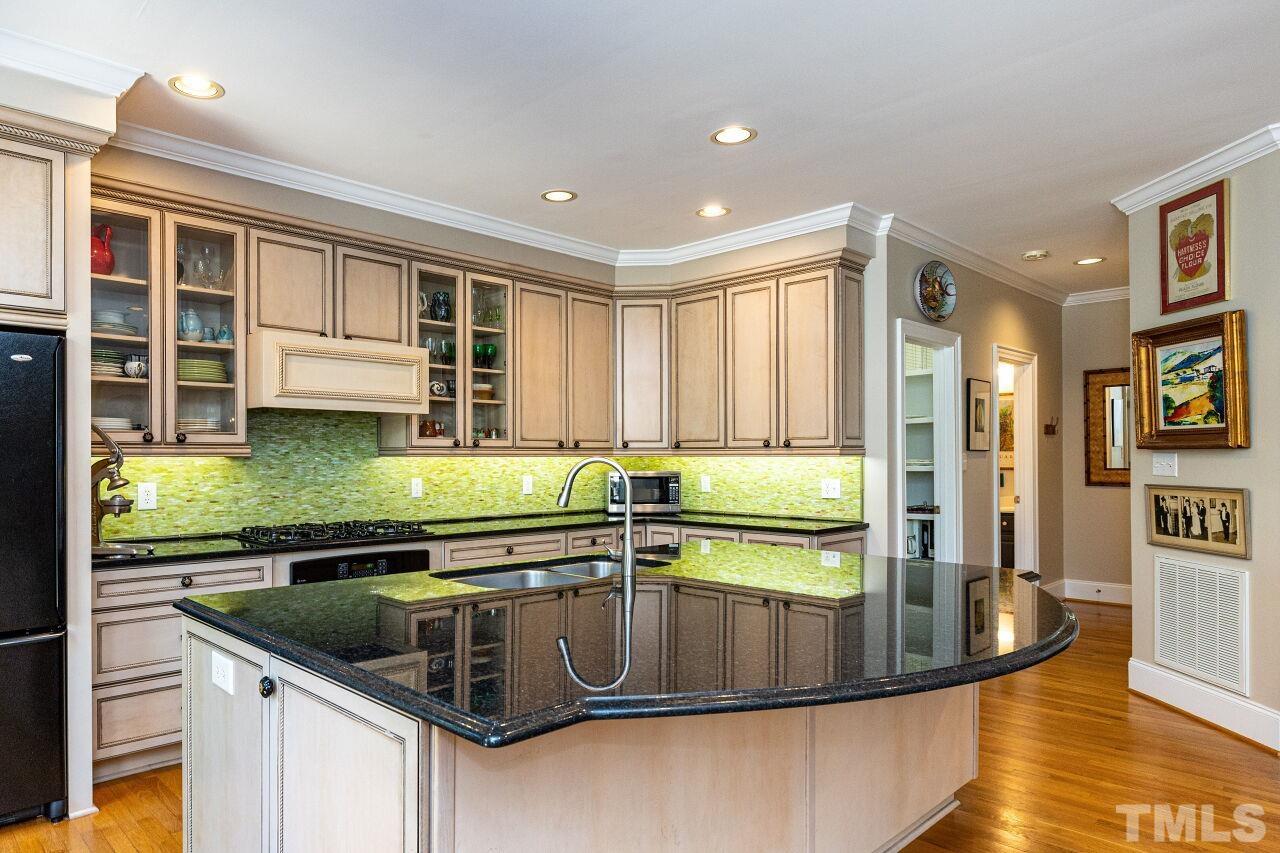 1124 Hobson Court Raleigh, NC 27607 - Photo 16 of 36 a kitchen with stainless steel appliances granite countertop a sink a stove and a refrigerator