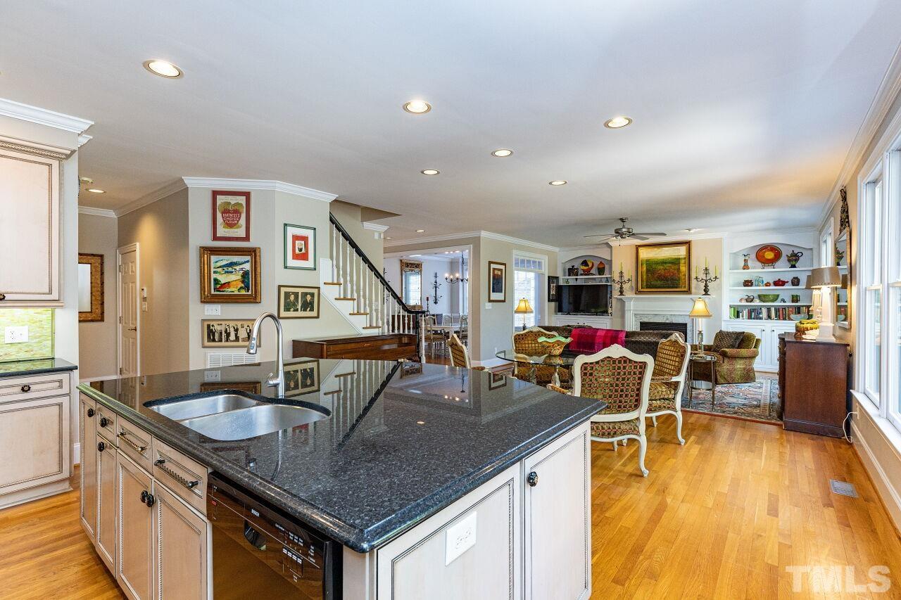 1124 Hobson Court Raleigh, NC 27607 - Photo 18 of 36 a kitchen with stainless steel appliances granite countertop a sink a table and chairs