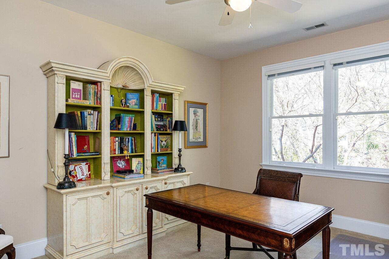 1124 Hobson Court Raleigh, NC 27607 - Photo 28 of 36 a view of a workspace with furniture and a book shelf