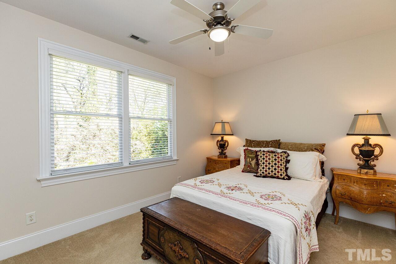 1124 Hobson Court Raleigh, NC 27607 - Photo 30 of 36 a bedroom with a bed and a chandelier