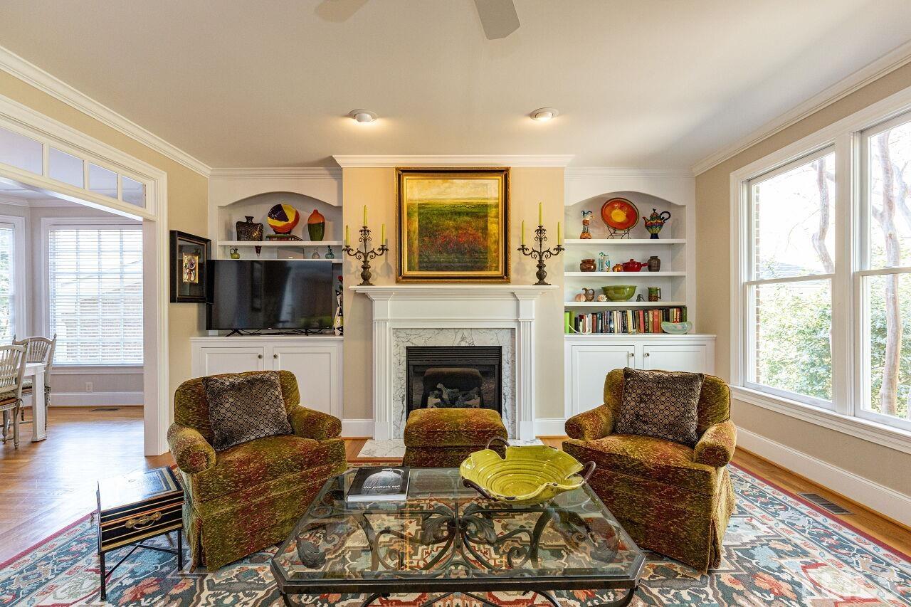 1124 Hobson Court Raleigh, NC 27607 - Photo 6 of 36 a living room with furniture a flat screen tv and a fireplace