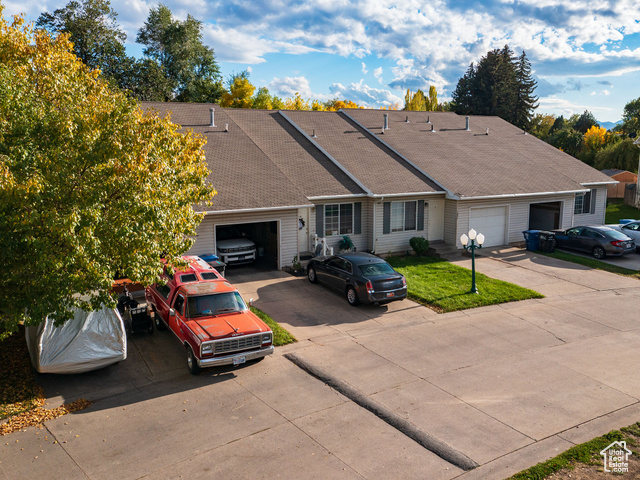190 West 700 North Logan, UT 84321 - Photo 12 of 51 Single story home featuring roof with shingles, driveway, and an attached garage