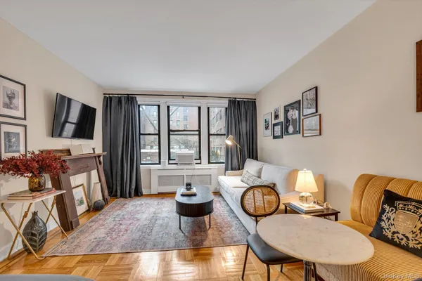 a living room with furniture fireplace and flat screen tv