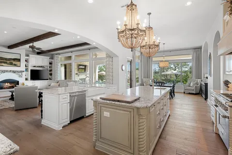 a view of a dining room with furniture a chandelier and wooden floor