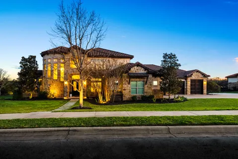 a front view of house with yard and swimming pool