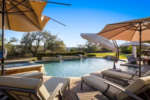 a view of swimming pool with outdoor seating space