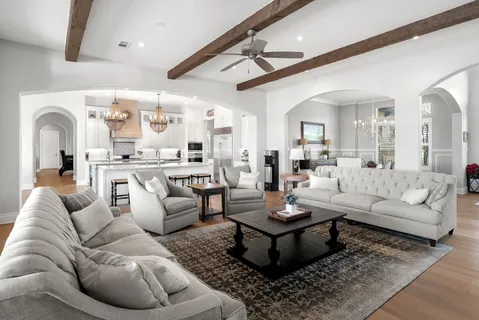 a kitchen with stainless steel appliances kitchen island granite countertop a table chairs and a chandelier