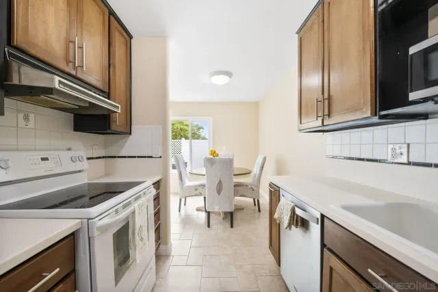 a kitchen with a sink cabinets and appliances