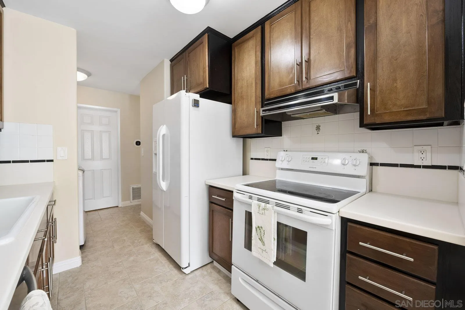 1246 Evergreen Drive Cardiff, CA 92007 - Photo 13 of 23 a kitchen with a refrigerator stove and sink