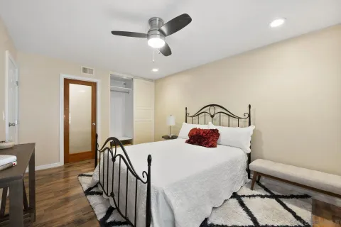 a bedroom with a bed and a chandelier