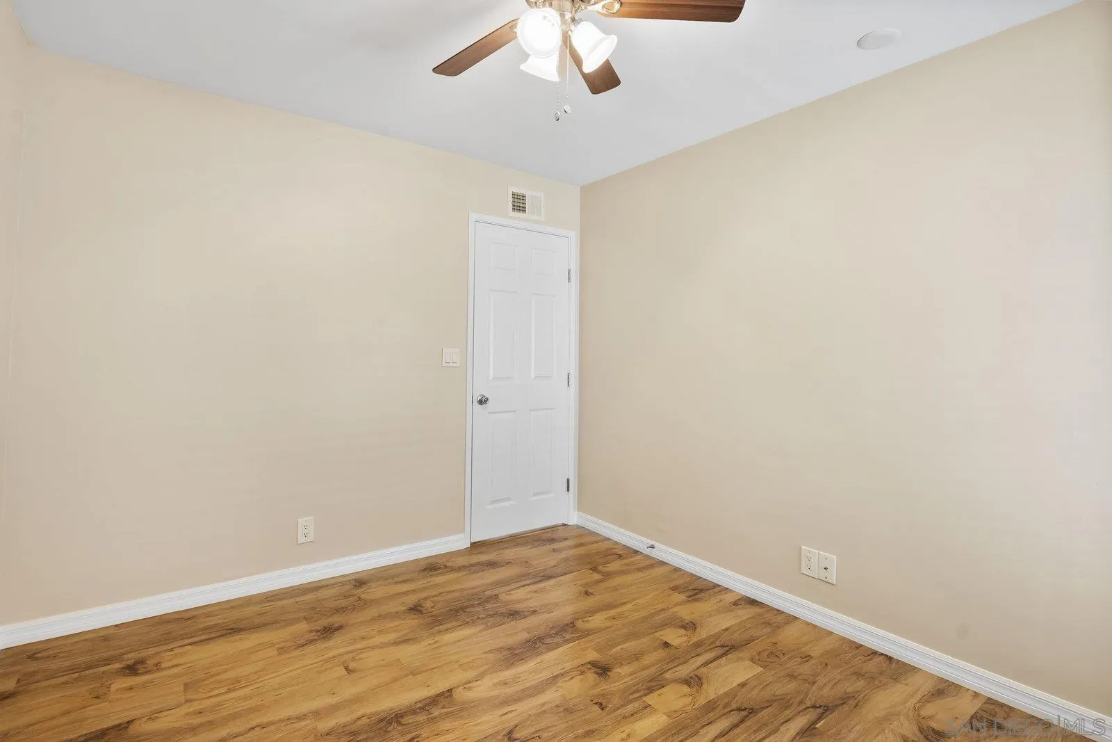 1246 Evergreen Drive Cardiff, CA 92007 - Photo 17 of 23 an empty room with a ceiling fan and wooden floor