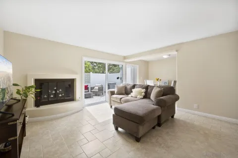 a living room with furniture a fireplace and a flat screen tv