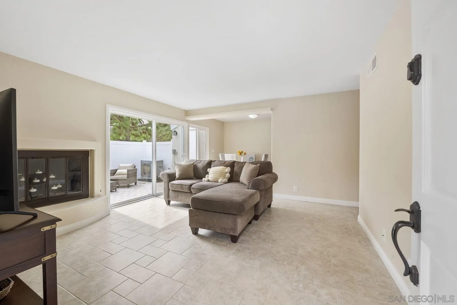 1246 Evergreen Drive Cardiff, CA 92007 - Photo 7 of 23 a living room with furniture a fireplace and a floor to ceiling window