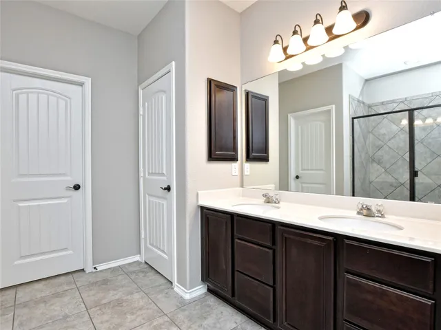 a bathroom with a double vanity sink and a mirror