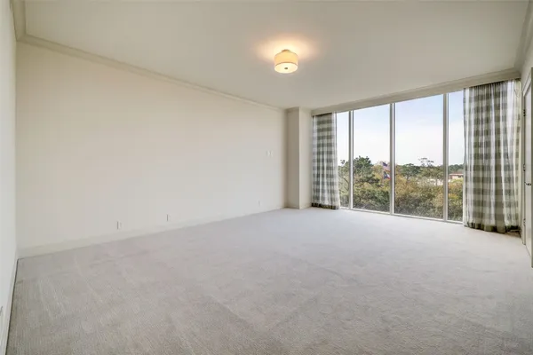 an empty room with large windows