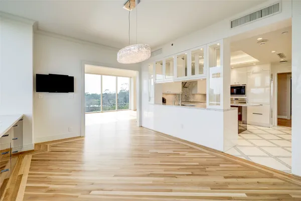 a view of a kitchen with wooden floor and windows