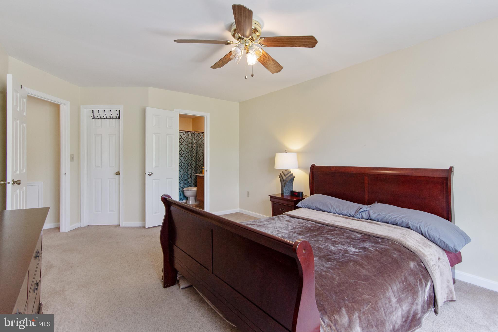 9304 Palmer Place, Unit 5 Laurel, MD 20708 - Photo 26 of 30 a bedroom with a bed and a chandelier