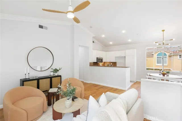 a living room with furniture a fireplace and a chandelier