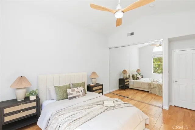 a bedroom with a bed and a chandelier fan