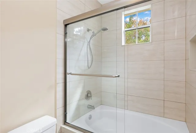 a bathroom with a shower and toilet