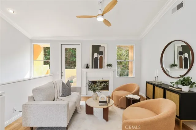 a living room with fireplace furniture and a large window