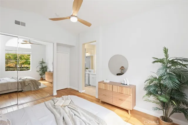a bedroom with a bed window and a potted plant