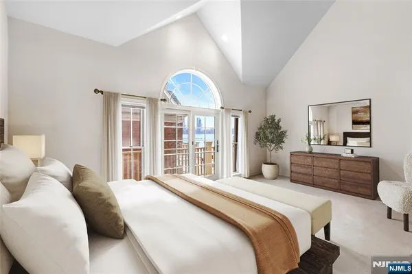a bedroom with a large bed and a large window