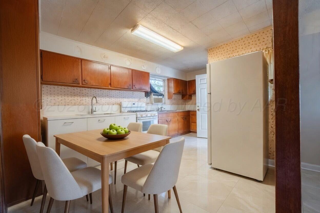 3007 Walnut Street Amarillo, TX 79107 - Photo 12 of 21 a kitchen with stainless steel appliances a dining table chairs and refrigerator