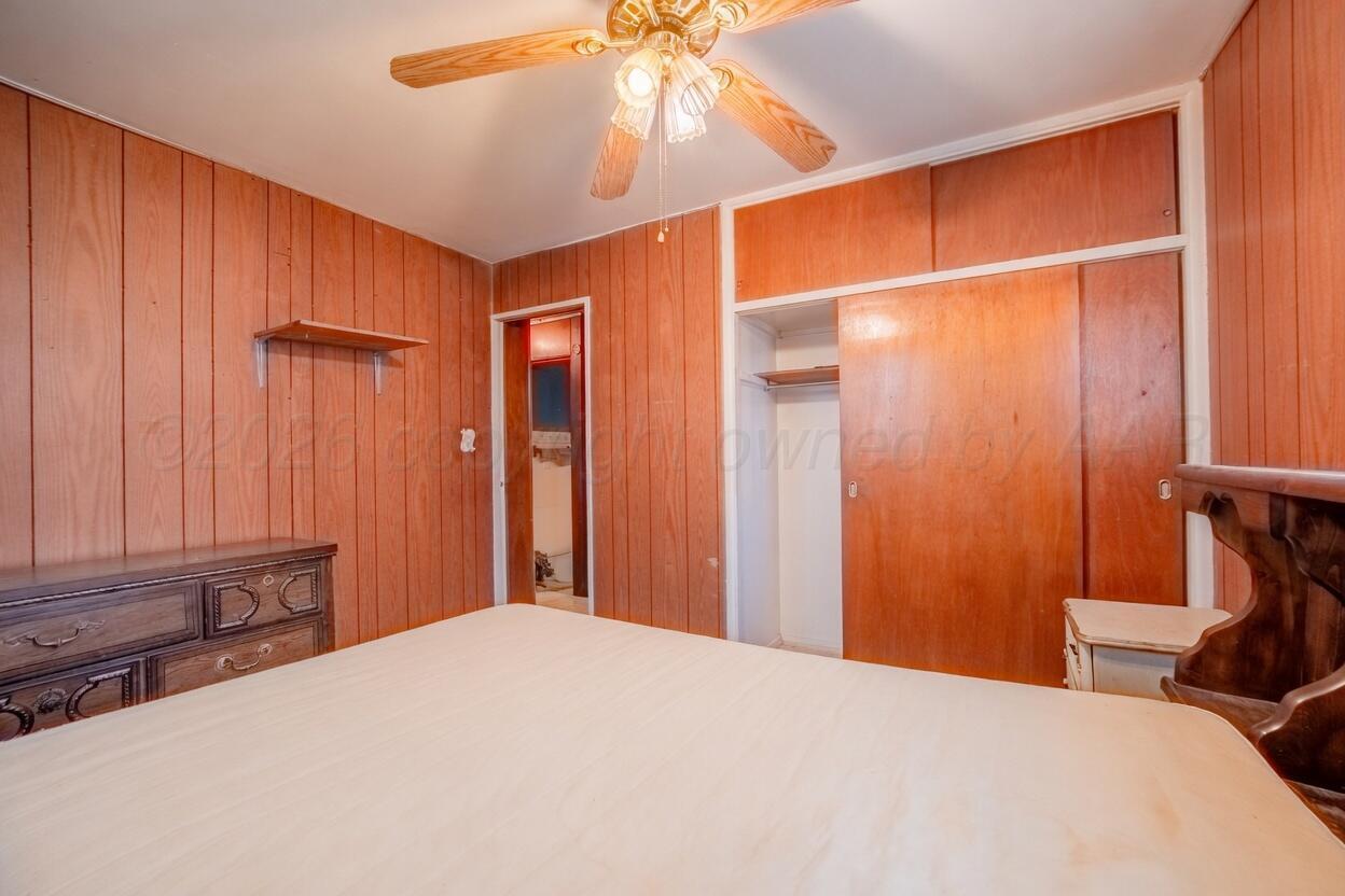 3007 Walnut Street Amarillo, TX 79107 - Photo 4 of 21 a bedroom with a bed and a chandelier