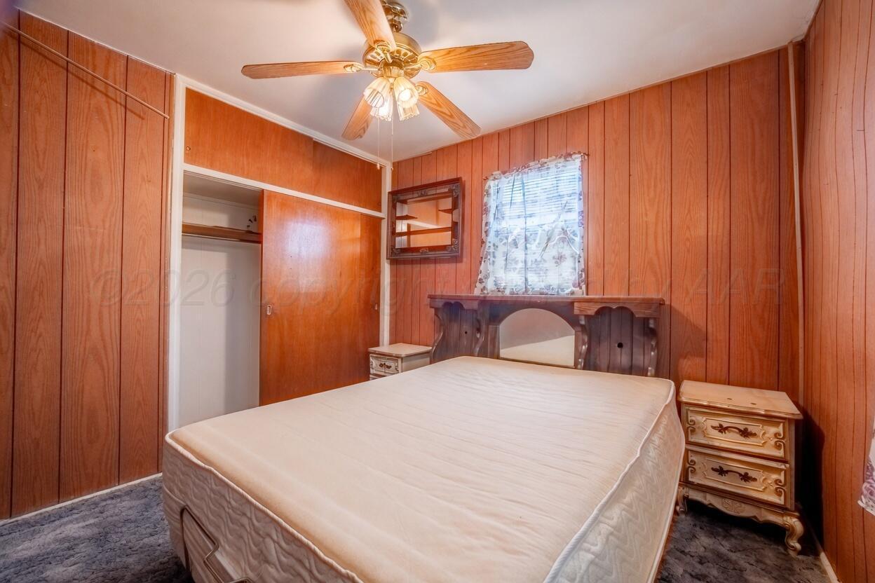 3007 Walnut Street Amarillo, TX 79107 - Photo 5 of 21 a bedroom with a bed and a chandelier