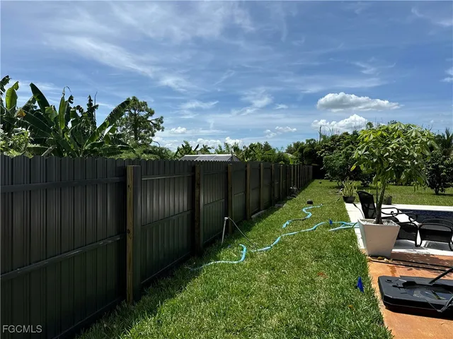 a view of a backyard with sitting area